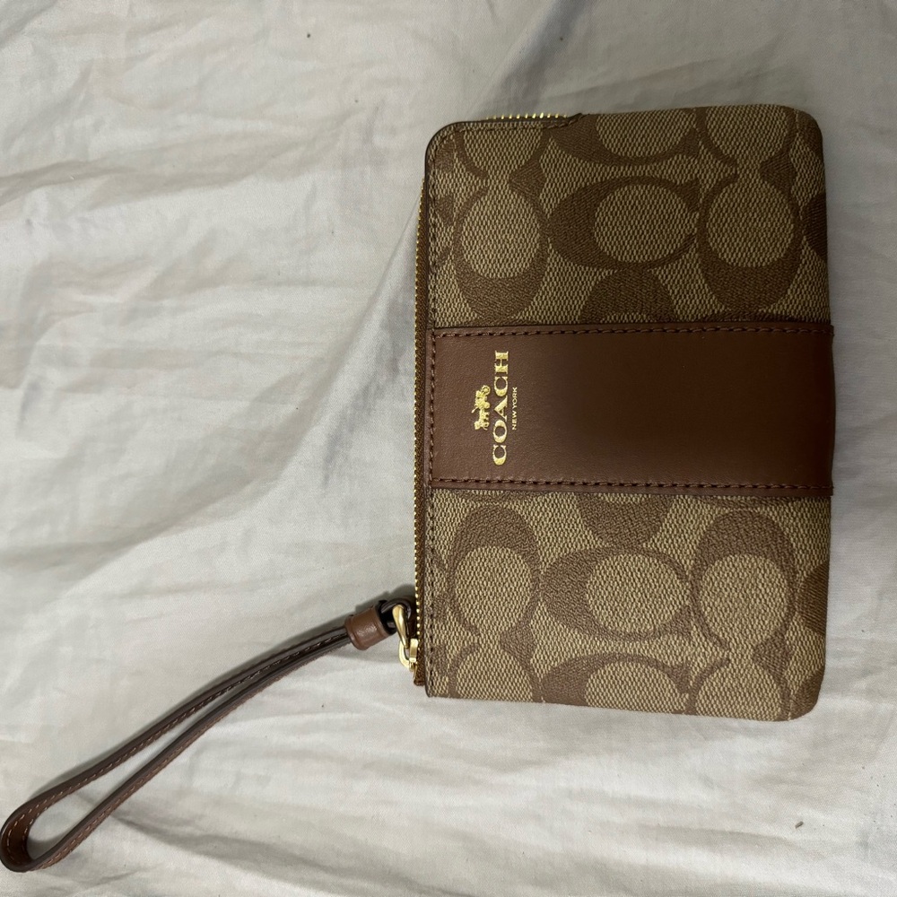 small coach bag that is for wrist wear. never used with tags inside.
